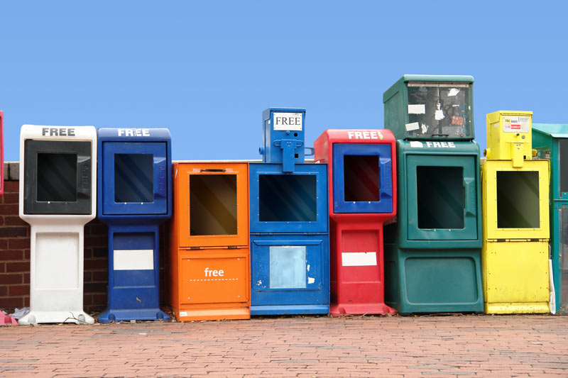 empty local newspaper stands following closures